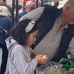 At a local market in Spain, selecting produce from a market stall.