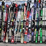Colourful skis standing up in a rack, by pasja1000 on Pixabay