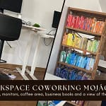 4 Images within 1 picture. From the relaxed seating area, to standing desks, a colourful bookcase with the books arranged in the colours of the rainbow and finally a view through the windows with the sea in the background.