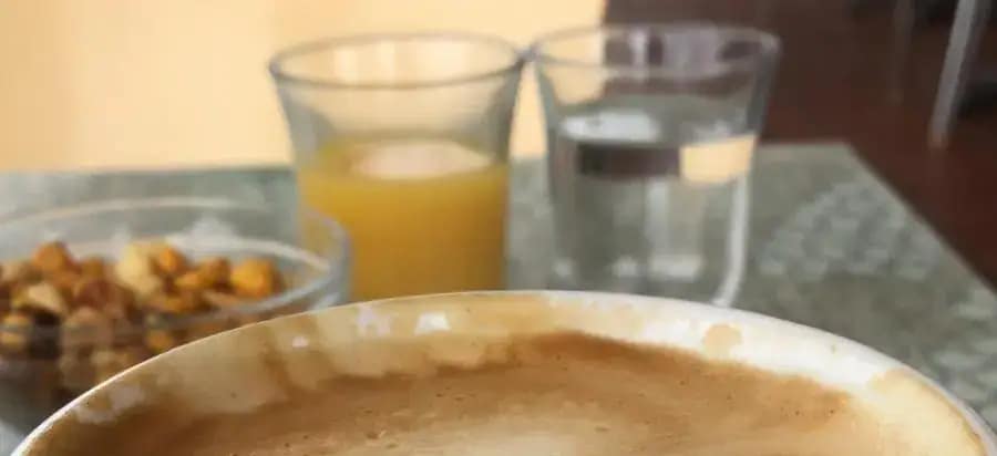 A risk of working from a local cafe, not just the coffee appears, but a small bowl of nuts, a small juice and a small water. Taking expensive real estate on your table for one